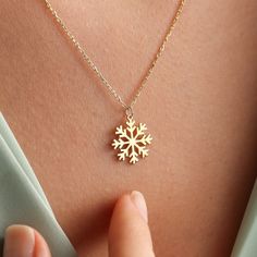 ✥ The perfect Christmas present, this 14k solid gold snowflake pendant combines classic style with joyous festive charm. The pendant, which is crafted in dazzling 14k pure gold, features a detailed snowflake design that exquisitely embodies the allure of winter. It elevates any ensemble with its sophisticated yet delicate design, making it the ideal accessory for the holidays. This snowflake pendant is a gorgeous option that will brighten her Christmas, whether you're looking for a special present for her or a sentimental piece of jewelry to commemorate the season. ✦ Metal Details✧ Metal Type: Solid Gold✧ Metal Purity: Available Options:14K | 18K✧ Metal Tone: Yellow Gold | White Gold | Rose Gold✧ Metal Certification: IDI Metal Authenticity Certificate✦ Chain Details:✧Chain Length: 14 Inche Elegant Snowflake Jewelry For Festive Occasion, Elegant Winter Jewelry As Gift, Fine Jewelry Snowflake Gift, Snowflake Necklace For Christmas Anniversary, White Gold Snowflake Jewelry For Christmas, Snowflake Jewelry For Holiday Gifts, Elegant Gold Snowflake Jewelry, Christmas Snowflake Necklace For Anniversary, Holiday Snowflake Jewelry For Gift