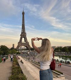 a woman standing in front of the eiffel tower