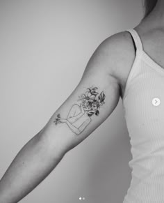 a woman with a flower tattoo on her arm