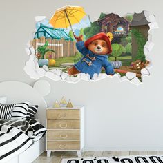 a wall sticker with a teddy bear holding an umbrella in it's hand