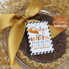 a close up of a plate of food with a ribbon on it and a card