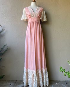 "Beautiful muted pink fairytale dress with lace detailing. So stunning!  --- Condition: Great vintage condition  --- Size: S  Shown on a size small mannequin with 26\" waist and 34\" bust Measurements:  --- @bluehoneyshop" Feminine Maxi Dress With Delicate Lace, Fitted Fairycore Dress With Lace Trim, Pink Lace Maxi Dress With Lace Trim, Pink V-neck Lace Dress, Pink Lace Trim Maxi Dress For Wedding, Pink Lace Trim Wedding Maxi Dress, Pink Spring Lace Dress With Delicate Details, Pink Delicate Lace Dress For Spring, Feminine Pink Dress With Delicate Lace