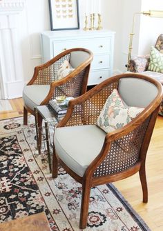 two chairs sitting next to each other on top of a rug