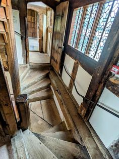 an old wooden staircase with stained glass windows