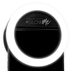 a black and white photo of a ring light on top of a cell phone with the words glow me written across it