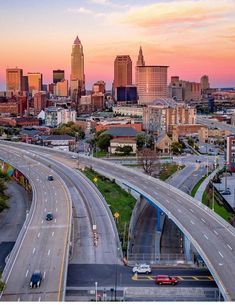 an aerial view of a highway and city skyline at sunset in atlanta, usa with cars driving on the road