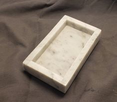 a marble tray sitting on top of a bed