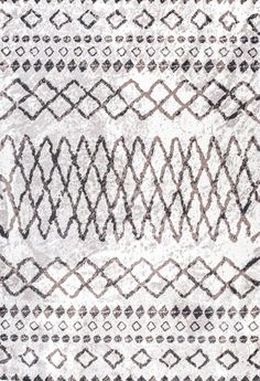 an area rug with black and white designs on it