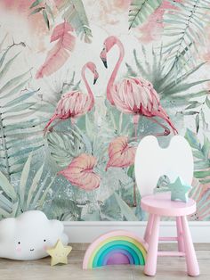 two pink flamingos standing in front of a wall mural with tropical leaves and rainbows