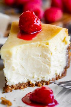 a slice of cheesecake with raspberries on top