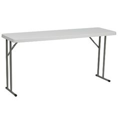 a white table sitting on top of a metal frame stand up desk with one leg extended