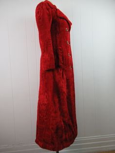 "Vintage late 1960s mod red floor length maxi coat. Made of plush velour or fleece-like patterned soft fabric. Double breasted. Fully lined in rose red Satin. Two pockets. Made by Lassie. Size small. Actual measurements are: Bust: 33\" waist: 31\" hips: 38 14.5\" shoulder seam to shoulder seam 23\" shoulder seam to cuff 53\" overall length Rear button vent is 28\", 10.5\" when buttoned. In excellent condition." Winter Velvet Outerwear With Button Closure, Long Red Outerwear With Buttons, Red Long Outerwear With Buttons, Red Velvet Outerwear For Fall, Vintage Velvet Winter Outerwear, Vintage Long Fitted Outerwear, Red Velvet Outerwear For Winter, Red Velvet Winter Outerwear, 1960s Coat