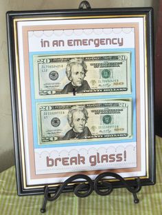 a sign that says in an emergency break glass on top of a stack of money