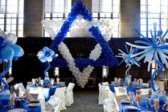 the tables are set up with blue and white decorations