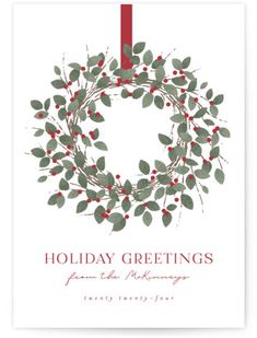 the holiday greeting card features a wreath with red berries and green leaves