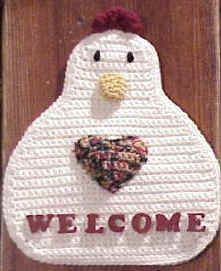 a welcome mat with a chicken holding a heart in it's beak and the words welcome