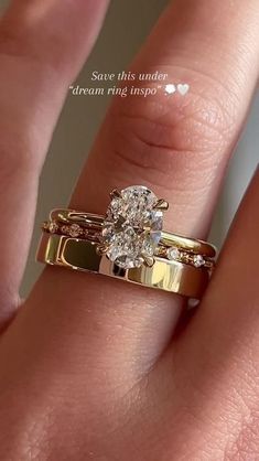 a woman's hand with a gold ring on it and a diamond in the middle