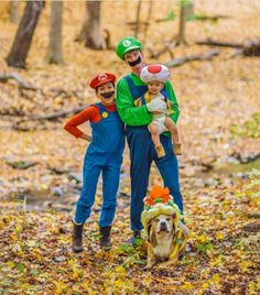 two men and a dog are dressed up as mario and luigi in the woods for halloween