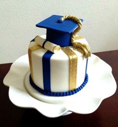 a white and blue graduation cake on a plate