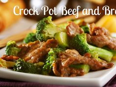 beef and broccoli on a white plate with chopsticks in the background