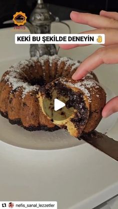 a person is cutting into a cake on a plate with a knife in front of it