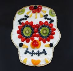 a decorated sugar skull cookie with fruit on it