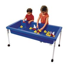 two children playing in a blue plastic table