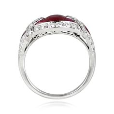 A gemstone ring centering a 1.08 carat oval cut natural ruby. French cut rubies set on either side of the center stone form a geometric design, which is accented by a halo of old European cut diamonds. A single French cut ruby and additional old European cut diamonds are set on each shoulder. The total weight of the additional diamonds is approximately 0.84 carats. The mounting is handcrafted in platinum, with openwork details on the under-gallery.
The measurements of this ring are approximately Oval Ruby Ring With Platinum, Oval Ruby Ring With Platinum Band, Oval Ruby Ring With Platinum Setting, Oval Ruby Ring With Platinum Center Stone, Art Deco Oval Diamond Ring With Accent Stones, Art Deco Ruby Ring With Diamond Details, Oval Cabochon Ruby And Diamond Ring, Classic Ruby Ring With Diamond And Polished Finish, Heirloom Oval Diamond Ruby Ring