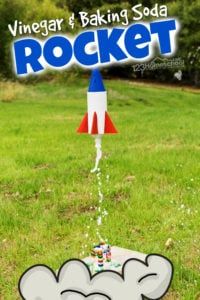 a rocket made out of legos in the grass with text reading vinegar and baking soda rocket