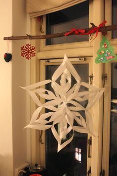 a paper snowflake hanging from a window