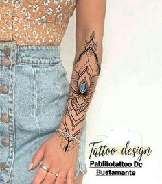 a woman's arm with a tattoo design on it and a diamond bracelet attached to her wrist