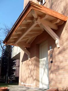 a wooden porch attached to a brick building