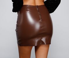 Get wrapped in this cute mini skirt that slays! The skirt features a high-rise waist. ruching. and a mini length with a wrap-style hem. The skirt is composed of a lined faux leather fabric that offers a form hugging fit with a moderate stretch. Complete look with a bustier and heels.Fit & Features High rise waist Ruching Mini length Wrap-style hem Faux leather fabric Form hugging fit. moderate stretch Runs true to size Cute Mini Skirt, Homecoming Outfits, Faux Leather Mini Skirt, Leather Mini Skirt, Take Charge, Glitter Dress, Cropped Blazer, Faux Leather Fabric, Selling Clothes