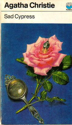 a book cover with a pink rose on it and a metal strainer next to it