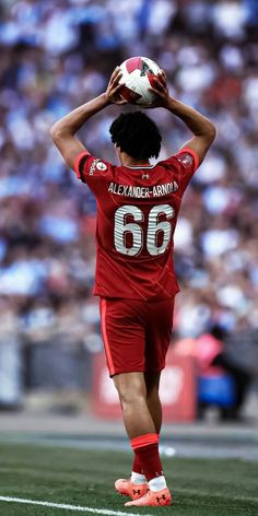 a soccer player holding a ball in his hands