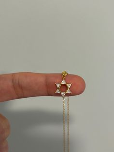 Dainty and so sparkly, perfect for everyday wear! Information: ✨Sterling Silver (925 stamped) | 14K Gold Plated ✨High quality AAA+ Cubic Zirconia gemstones ✨Adjustable length: 16" - 18" ✨Hypoallergenic ✨Tarnish resistant Our Star of David necklace is minimalist and so elegant. The necklace is made with a high grade of craftsmanship and attention to detail, each stone is clear and highly polished for a strong sparkle. The necklace is adjustable from 16" to 18", allowing you to find the perfect fit and create multiple layering styles. Our necklace makes a perfect gift! Gold Magen David Necklace, Jewish Star Necklace, Star Of David Necklace, Jewish Star, Necklace Diamond, Layered Fashion, Diamond Gold, Necklace Dainty, Star Of David