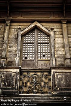 an old building with wooden doors and windows