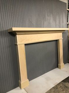 an unfinished fireplace in a room with gray walls