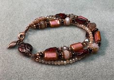 Stunning, 3 strand beaded bracelet, handcrafted with beautiful 12x8 Rectangle CZECH table-cut glass beads in lovely shades of coral pink and burnt red umber. Accented with fire polish Picasso beads, genuine copper spacers  complimenting floral and coin bead. All my bracelets are approximately 7.5 inches in finished length, intended to be worn loosely & secures with a lobster clasp. I can accommodate custom orders too in different sizes and a wide of colors, Wear this lovely bracelet and be the t Bohemian Double Strand Bracelet With Faceted Beads, Handmaid Jewelry, Czech Beads Jewelry, Gemstones Chart, Handmade Bead Jewellery, Shades Of Coral, Czech Glass Jewelry, Burnt Red, Jewelry Styles