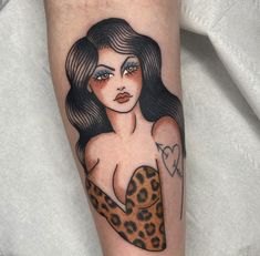 a woman's arm with a tattoo on it and a cheetah print