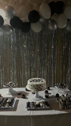 a table topped with a cake and desserts