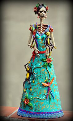 a statue of a skeleton wearing a blue dress