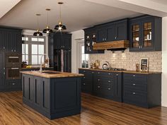 a large kitchen with wooden floors and dark blue cabinetry, along with an island