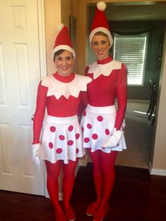 two women dressed in costumes standing next to each other