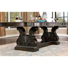 a dining room table with an ornate base