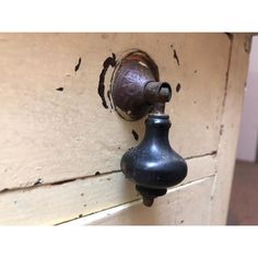 an old fashioned door knob with a rusted metal handle on it's side