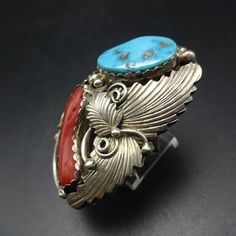 "VINTAGE NAVAJO RING DESCRIPTION: This spectacular ring features Sleeping Beauty turquoise and old red Mediterranean branch coral. The gemstones are secure in scalloped bezel, on a foundation of heavy gauge vintage sterling silver. Highly detailed applied leaves enhance the face of the ring. This impressive ring will be a treasured addition to your collection of fine vintage Native American jewelry. MEASUREMENTS: Ring face measures 2\" x 1 1/4\" Turquoise cabochon measures 20mm x 13mm RING SIZE: Vintage Red Gemstone Jewelry, Southwestern Style Red Ring Jewelry, Southwestern Style Red Turquoise Ring, Vintage Multi-stone Collectible Rings, Red Southwestern Style Collectible Jewelry, Southwestern Multi-stone Red Ring, Southwestern Red Multi-stone Ring, Red Southwestern Multi-stone Rings, Unique Red Multi-stone Turquoise Ring