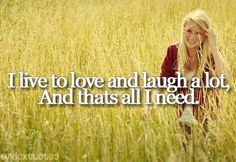 a woman standing in tall grass with the words i live to love and laugh at a lot