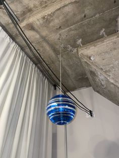 a blue light hanging from the ceiling in a room