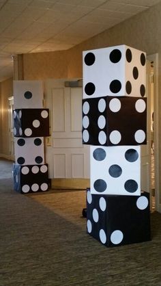 three large black and white blocks with polka dots on them in an office lobby area